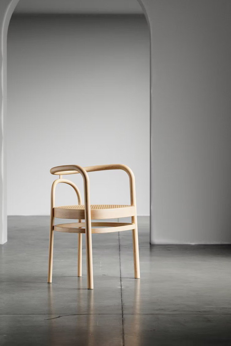 Photoreal furniture product render of a cane dining chair in a minimal studio setting