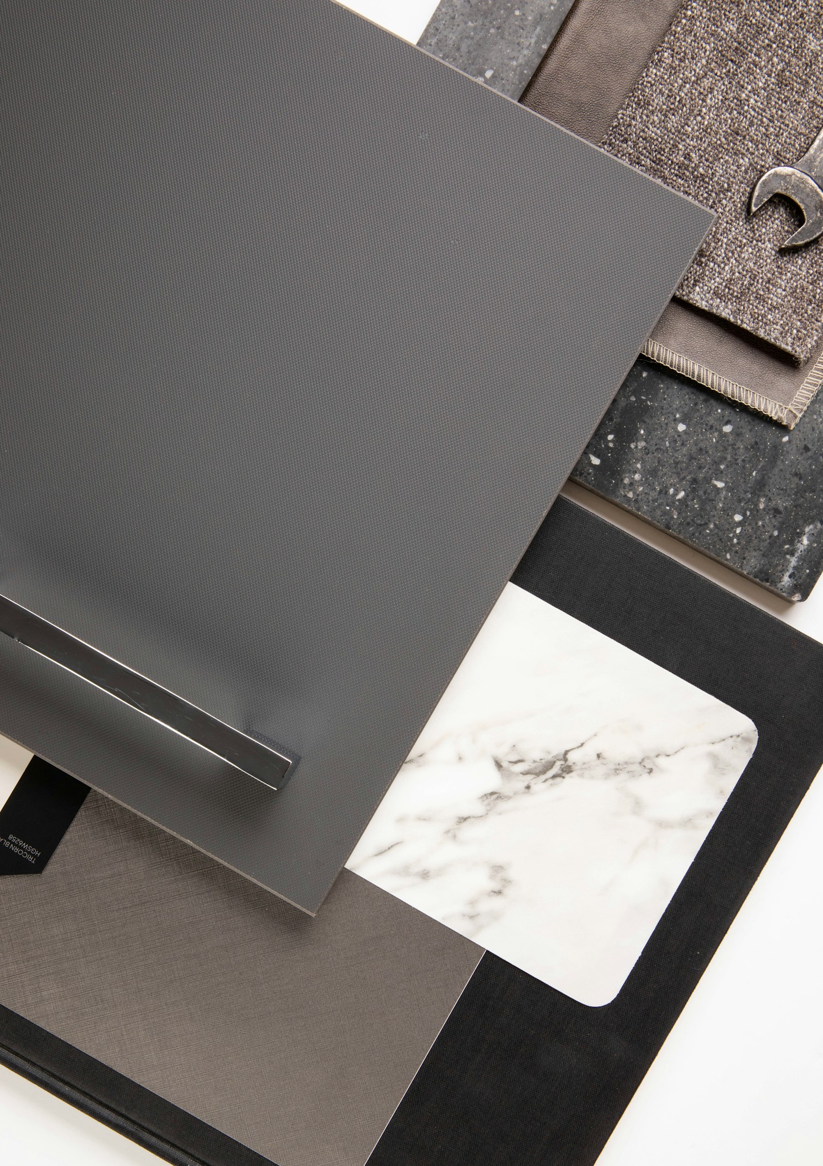 Material samples: a cabinet front with handle, marble, stone and fabric